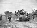 Australian troops from the 2/43rd Battalion advance with a Matilda tank on Maeda-shima in a sweep mission to clear the area of Japanese troops, 12 June 1945
