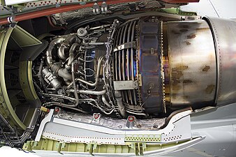 This view shows the way turbine blade tip clearance is controlled actively (passive control is by material selection and internal air system cooling) using cooling-air tubes (for low pressure turbine blade tip to shroud clearance control) which circle the iridescent turbine casing on a CFM International CFM56. Cooling air manifold (smooth flat surface), to left of LPTCC tubes, for high pressure turbine blade tip clearance control.[125] Active control comes from activation of valves which supply cooling air to the tubes at appropriate flight conditions.