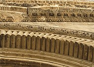 Several levels of architectural decoration over the doors of the Church of the Holy Sepulchre