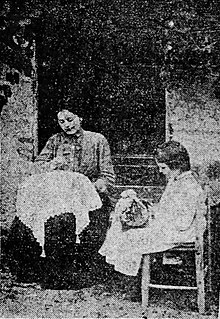 A woman and a child sewing in a garden.
