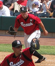 A baseball player in red and gray