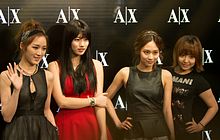 An image of Miss A, with the logo of Armani Exchange at the back.