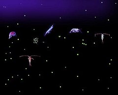 Six relatively large variously shaped organisms with dozens of small light-colored dots all against a dark background. Some of the organisms have antennae that are longer than their bodies.