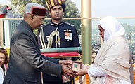 Nazir Wani's wife (right) receives the Ashoka Chakra on his behalf from the President of India.