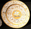 "Dish with an Angel" attributed to Willem Jansz. Verstraeten with arabesques on the rim reminiscent of the Urbino style tin-glazed ware, Rijksmuseum
