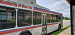 A longer white, red and blue bus