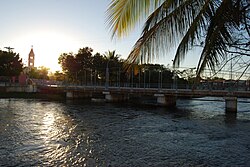 Bridge crossing the Das Éguas River with Church of Our Lady of Gloria in the background