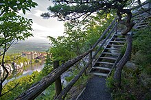 A stairway trail on the side of a hill overlooking a river