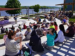 Summer crowd enjoying an outdoor Riverfront Amphitheater eagle program.