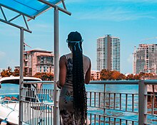 A woman standing by the water.