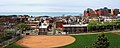The baseball field of Bloomfield Park in the foreground, with residential dwellings in the center of the image. The top right of the image shows Children's Hospital of Pittsburgh. Image taken from the Bloomfield Bridge. Pittsburgh, Pennsylvania, USA