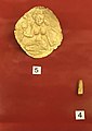 Golden leaf with Lakshmi figure. Golden lingam amulet