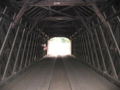 Interior structure of a covered bridge utilizing a plank-lattice structure