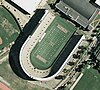 Aerial view of Harvard Stadium in Boston, in the form of a letter U with a capital H in the center of the field and the words Harvard and Crimson at either end