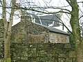 The vaulted chamber building with the 17th-century house in the background.