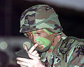 Soldier with a painted face for camouflage