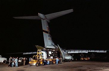 The Apollo 11 mobile quarantine facility, with the crew on board, is unloaded from a C-141 aircraft.