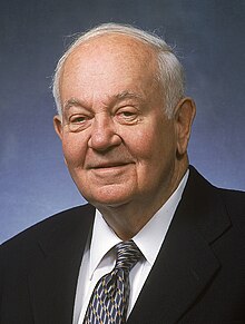 Portrait of an older Glen P. Robinson. He is wearing a suit and a tie.