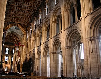 Peterborough Cathedral, the three-stage nave 1155–1175 has piers of ovoid section with attached shafts. While the forms are typically Norman, the length is greater than found in Normandy. The wooden ceiling is original.