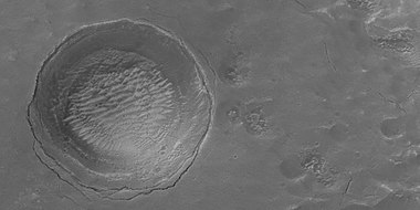 Depression forming from a possible subsurface loss of material, as seen by HiRISE under HiWish program