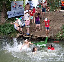 People jumping into a river