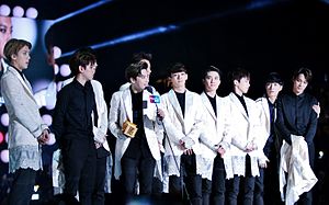 Exo standing on stage receiving an award at the Mnet Asian Music Awards in 2014