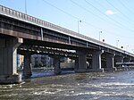 Two non-identical box girder bridges over rapids.