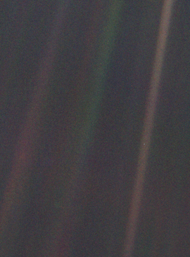 Dark gray and black static with colored vertical rays of sunlight over part of the image. A small pale blue point of light is barely visible.