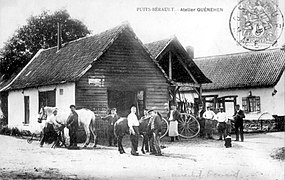 A French travail is in the background, between buildings, of this 1905 blacksmithy.