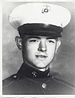 A black and white head shot image showing Smedley in his military dress uniform with hat.