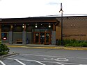 The Wayzata Library, a traditional brick building with square columns and a street lamp.