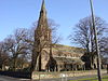 A large stone church with a clerestory and west steeple