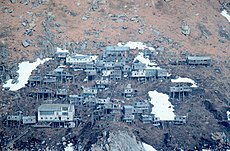 Abandoned stilt village Ugiuvak, photographed 1978. The large white building near the bottom of the slope is the former Bureau of Indian Affairs school.