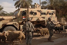 Iraqi Light Armored Vehicle and US Army Soldiers