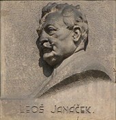 wall plaque with profile of a man's head; he is elderly with a moustache and a full head of hair