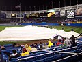 The grounds crew taking the tarp off the infield