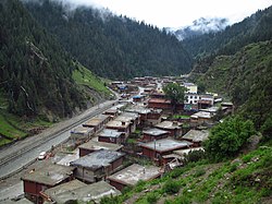 View of traditional log homes along the Pal Chu (river) in Babang Township