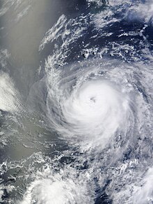 A visible satellite image of an intensifying Category 2 hurricane out at sea.
