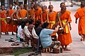 Image 37Monks gathering morning alms (from Culture of Laos)