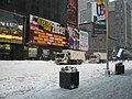 Times Square, NYC, during the February 2003 winter storm. Image shows the city garbage collection trucks outfitted with snow plows and scoops.