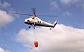 An MNR contract firefighting aircraft at work: a S-58T with bambi water bucket, near Dryden, Ontario, 1995