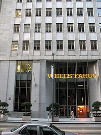 A color photograph of the front of a building, with a sign reading "WELLS FARGO" above the entryway