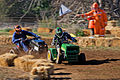 Image 23 Lawn mower racing Photo credit: Fir0002 Two racers cross the finish line of the 250cc class at the 2007 Swifts Creek lawn mower races. In this motorsport, competitors race modified lawn mowers, usually of the ride-on or self-propelled variety. Original mower engines are retained but blades are removed for safety. Lawn mowers have also been used in kart racing, a different sport. More selected pictures