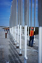 The mining near the Lac de Gras lakes needs the construction of Frozen Dam Cores with heat pipes for creating permafrost. Here, this artificially created frozen ground prevents seepage from a containment pond for tailings.