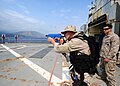 An Operations Specialist practices small-arms tactics, aboard the training ship Aris (A 74) at the NATO Maritime Interdiction Operational Training Center