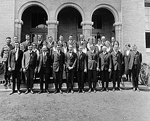 Black and white group portrait of men and women standing