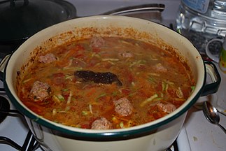 Mexican meatball soup simmering on a stove