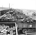 Drums of oil being transferred from rail cars to lorries, WWII