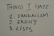Graffiti on a wall reading "Things I hate: 1. Vandalism 2. Irony 3. Lists"