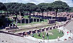 Photo des ruines du théâtre vue du haut des marches. La place et les colonnes sont au second plan.